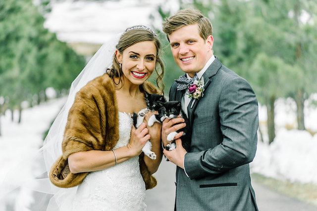 bride and groom holding tuxedo kittens