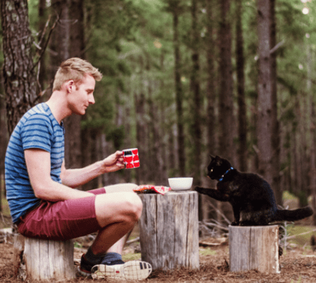 man travels with his calico cat through Australia in a van